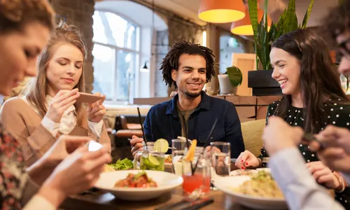 Host seating guests using digital table plan on screen