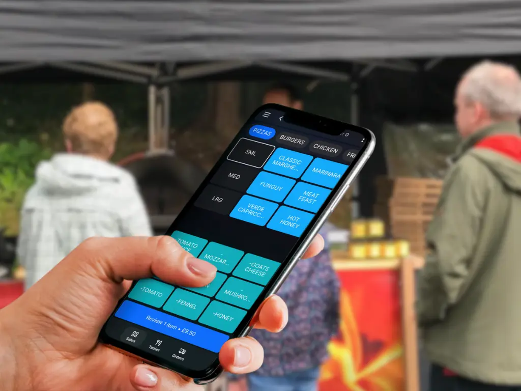 Mobile trader using TapaGo point of sale at a market