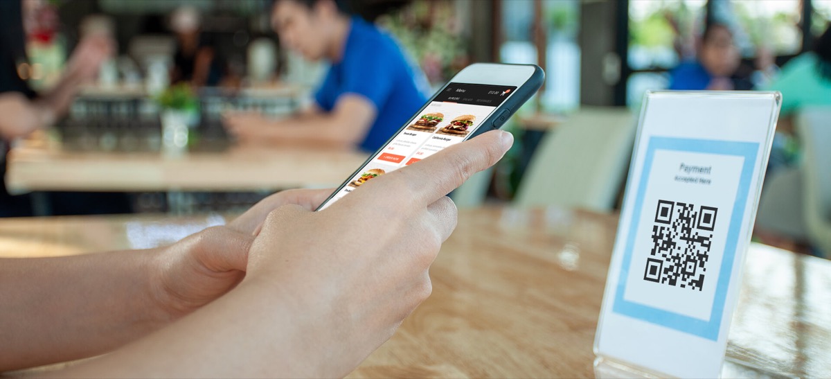 Scanning a QR code at a restaurant table to place an order